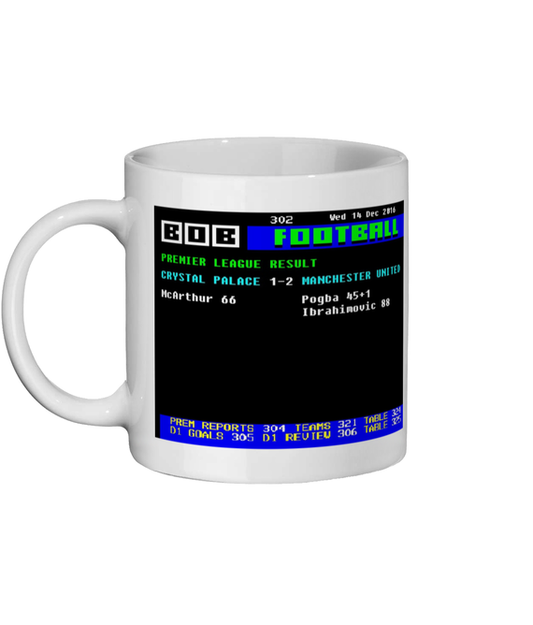 White mug with a digital display of football results on a black background